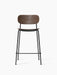A front view of the Co Counter Chair, featuring a dark stained oak veneer seat and backrest on a slender black steel frame.