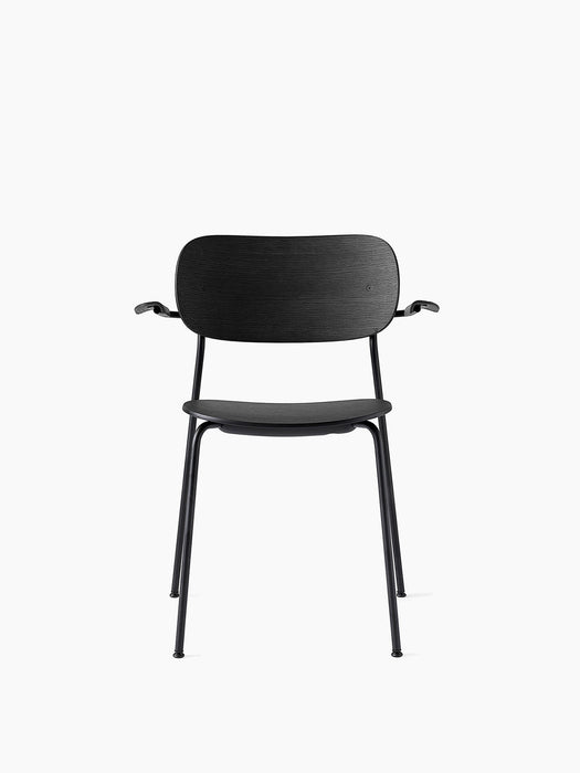 Front view of the Co Dining Chair with armrest in black oak veneer and black powder-coated steel frame on a white background