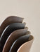 Detailed shot of the curved veneer backrests of several Co Dining Chairs, highlighting the different oak finishes available.
