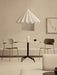 Two olive Co Dining Chairs with armrests placed at a round Harbour Column Dining Table under a white Dancing Pendant light.