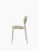 Side view of the Co Dining Chair, Outdoor in ivory without armrests, showing its slim metal frame and recycled plastic seat.
