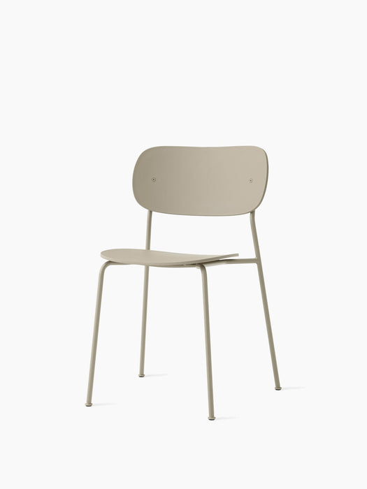Angled view of the Co Dining Chair, Outdoor, in ivory. The minimalist chair features a slim metal frame and no armrests.
