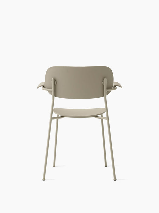 A back view of the Co Dining Chair, Outdoor with armrests, in a muted, solid colour against a white background.