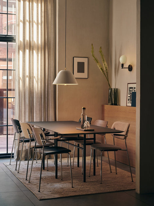 Co Dining Chairs around a Snaregade table on a Houkime Rug, illuminated by a Levitate Pendant light in a cosy dining room.