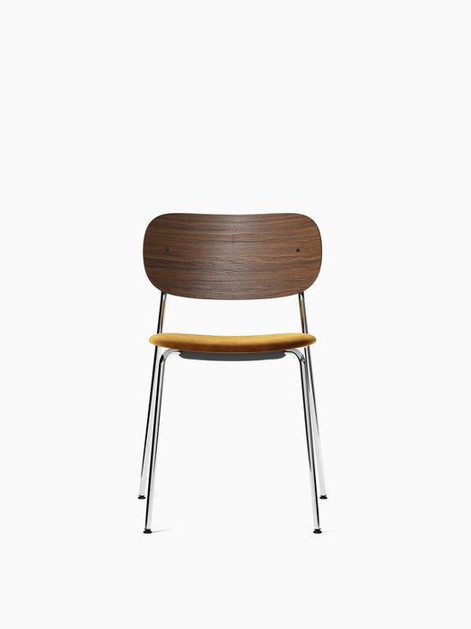 Front view of the Co Dining Chair, featuring a dark stained oak backrest, a yellow upholstered seat, and a slim chrome frame.