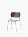 Angled view of the Co Dining Chair with a dark stained oak back, a light bouclé upholstered seat, and a slim chrome frame.