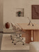 A calm office setting featuring two Co Task Chairs at an Androgyne Dining Table with an Interconnect Candle Holder on top.