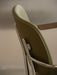Close-up on the back of the Co Task Chair, detailing the olive green upholstery and polished aluminium frame with armrest.