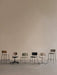 A row of six chairs from the Audo Co Collection, showcasing the Co Task Chair, Dining Chair, and Bar Stool models.