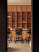 Office with Co Task Chairs at a Co Table. A background bookcase displays an Interconnect Candleholder and Column Lamp.