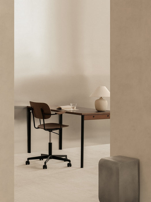 A minimalist office with a Co Task Chair at a Co Table. A Torso Table Lamp is on the desk, and a Volume Side Table is nearby.