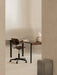 A minimalist office with a Co Task Chair at a Co Table. A Torso Table Lamp is on the desk, and a Volume Side Table is nearby.