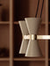 Close-up of the Collector Chandelier, 5, with cream-coloured, perforated hourglass shades on a polished brass arm.