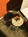 An outdoor setting with a Column Table Lamp on a Harbour Column Table, surrounded by WM String Chairs on a wooden deck.