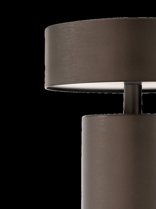 A close-up of the Column Table Lamp, Portable in bronzed aluminium, showing the brushed texture on its shade and base.