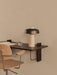 A close-up, angled view of the dark wood Corbel Desk styled with a Reverse Table Lamp and a light wood Co Task Chair.