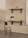 A minimal study corner featuring a wall-mounted Corbel Desk and Shelf with an Afteroom Chair and Reverse Table Lamp.