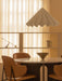 A dining room featuring a white Dancing Pendant Lamp over an Androgyne Dining Table, Penguin Dining Chairs and a Taper Bowl.