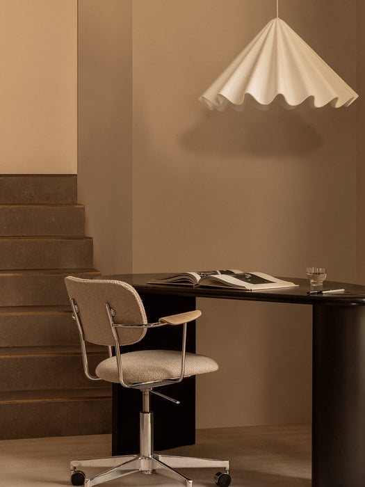 A white Dancing Pendant Lamp hangs over a black Eclipse Desk and a beige Co Task Chair in a minimalist office setting.