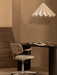 A white Dancing Pendant Lamp hangs over a black Eclipse Desk and a beige Co Task Chair in a minimalist office setting.