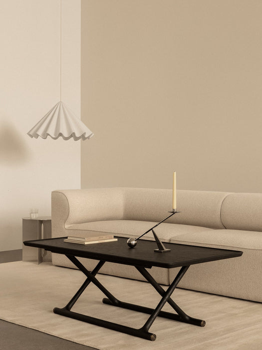 A white Dancing Pendant hangs over a black Jager Lounge Table and beige Eave Modular Sofa in a modern living room.