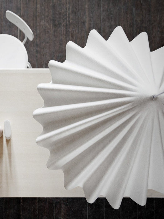 A top-down, close-up view of the white Dancing Pendant Lamp, showing its pleated, felt-like texture and wavy edge.