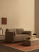 A minimalist living room featuring the brown Offset Sofa Bed, a Plinth Low marble table with a Reverse Lamp, on a Duomo Rug.