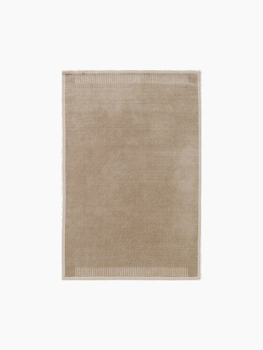 A top-down view of the rectangular Duomo Rug in Limestone Beige, showing a solid-coloured body and decorative ribbed borders.