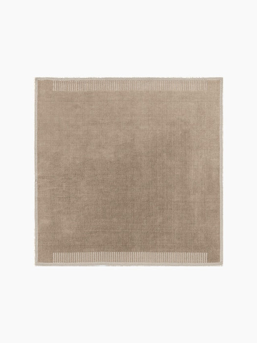 Top-down view of the square Duomo Rug in Limestone Beige. It has a decorative border with vertical stripes and fringed edges.