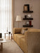 Eave Modular Sofa in a yellow textured fabric, styled in a modern living room with decorative shelves and soft lighting.