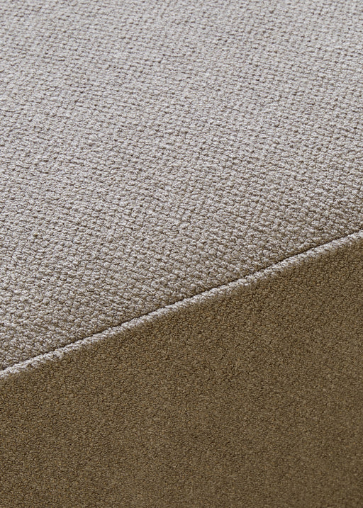 Close-up of the Eave Modular Sofa's upholstery, showing the nubby texture of the light brown Audo Bouclé fabric.