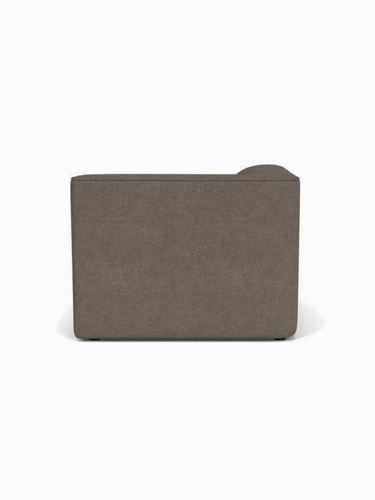 Back view of the Eave Modular Sofa, 96, Chaise Longue. Upholstered in a dark textured fabric, it has a low rectangular shape.