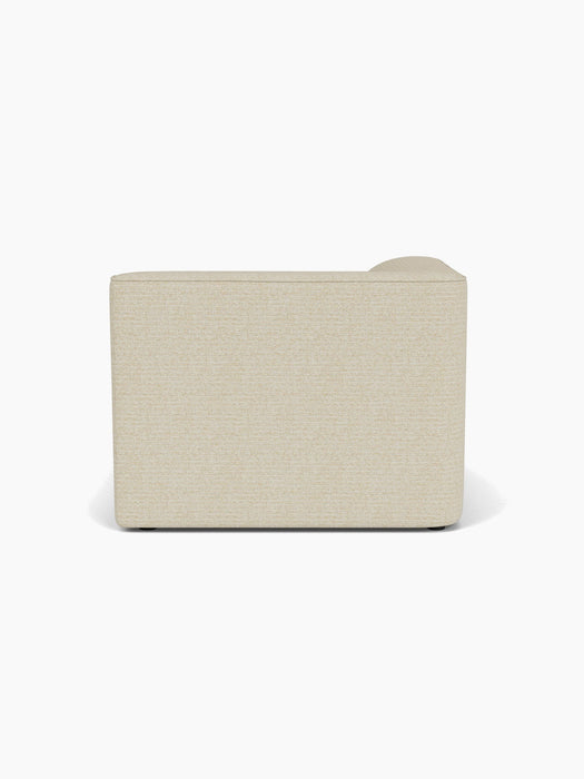 Back view of the Eave Modular Sofa 96 Chaise Longue, upholstered in a light beige textured fabric against a white background