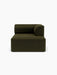 A front-facing view of the Eave Modular Sofa, 96, Chaise Longue. The right-hand module is upholstered in dark green fabric.