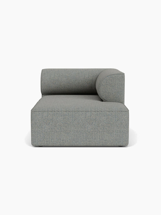 A front-on view of the grey, textured Eave Modular Sofa, 96, Chaise Longue, featuring a deep seat and a low, curved backrest.