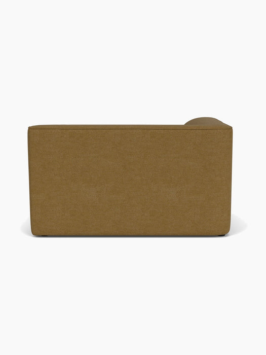 Back view of the Eave Modular Sofa, 96, Corner 144 module upholstered in a textured, mustard-brown Audo Bouclé 06 fabric.