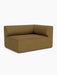 A studio shot of the Eave Modular Sofa, 96, Corner 144. This corner module is upholstered in a rich brown bouclé fabric.
