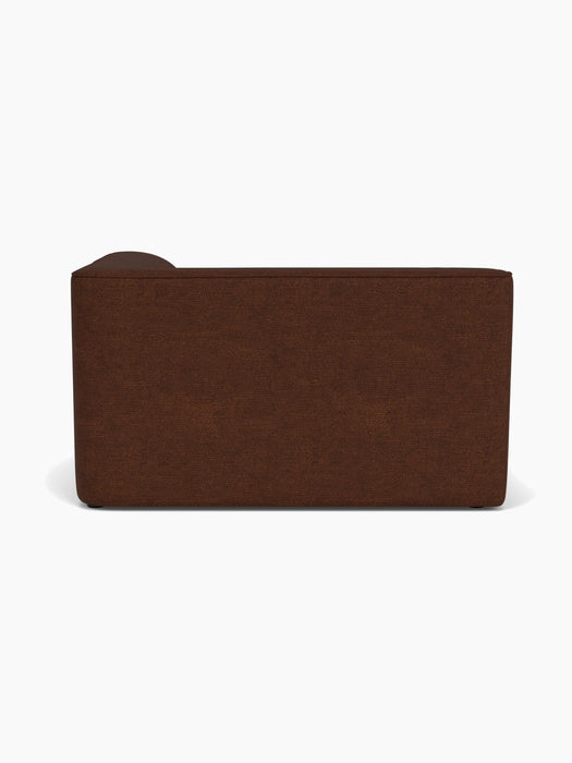 A back view of the Eave Modular Sofa, 96, Corner 144, upholstered in a dark brown bouclé fabric against a white background.