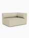 Angled view of the Eave Modular Sofa, 96, Corner 144 right-hand module, upholstered in a light beige textured fabric.