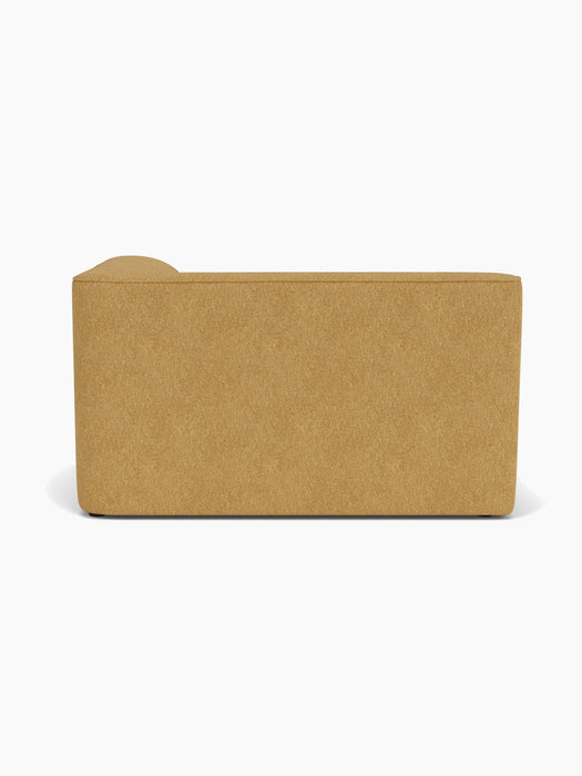 Back view of the Eave Modular Sofa, 96, Corner 144, upholstered in a textured, mustard-yellow fabric on a white background.