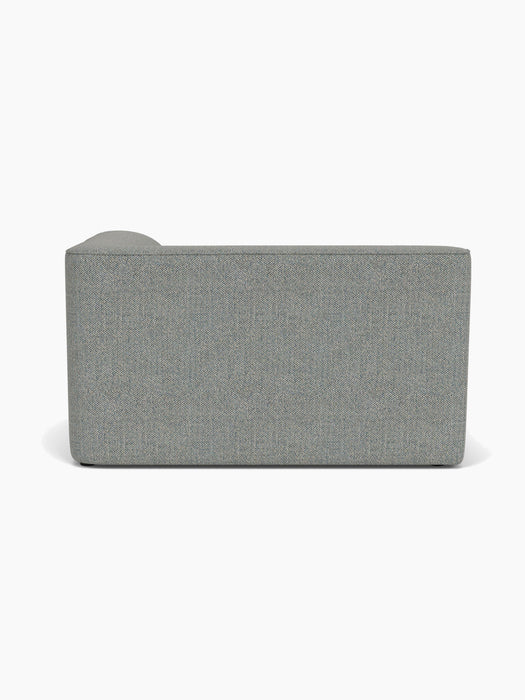 A back view of the Eave Modular Sofa, 96, Corner 144, shown in a light grey textured fabric against a white background.