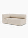 A minimalist Eave Modular Sofa, 96, Corner 192, upholstered in a light beige fabric, featuring a curved back and deep seat.