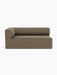 A front view of the Eave Modular Sofa, 96, Corner 192 left module, upholstered in a textured brown Safire 001 fabric.