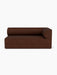 Front view of the Eave Modular Sofa, 96, Corner 192 in dark brown bouclé, with a low, curved backrest and right armrest.