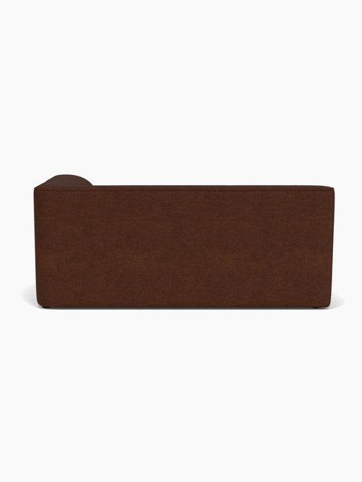 A full back view of the Eave Modular Sofa, 96, Corner 192, upholstered in a rich, dark brown bouclé fabric.