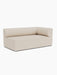 An angled view of the Eave Modular Sofa, 96, Corner 192, in a light-coloured fabric, displayed against a white background.