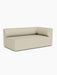 A three-quarter view of the Eave Modular Sofa, 96, Corner 192, upholstered in a textured, light beige fabric.