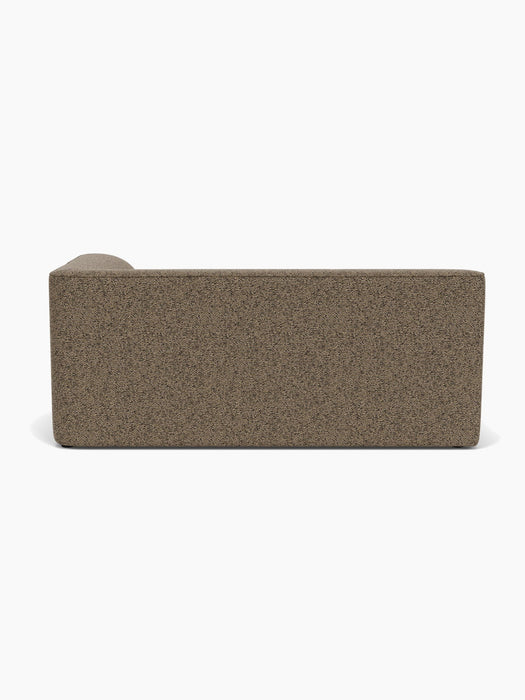 A back view of the Eave Modular Sofa, 96, Corner 192, upholstered in a brown textured Safire 001 fabric.