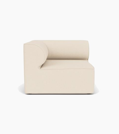 Front view of the Eave Modular Sofa, 96, Corner, upholstered in a light cream fabric with a distinctive curved backrest.
