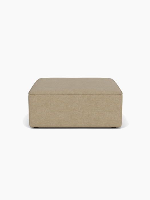 Front view of the Eave Modular Sofa Pouf, a square ottoman in light brown Audo Bouclé 02 fabric on a white background.
